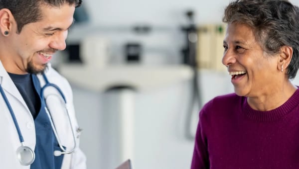 Doctor and patient smiling during an in-person visit
